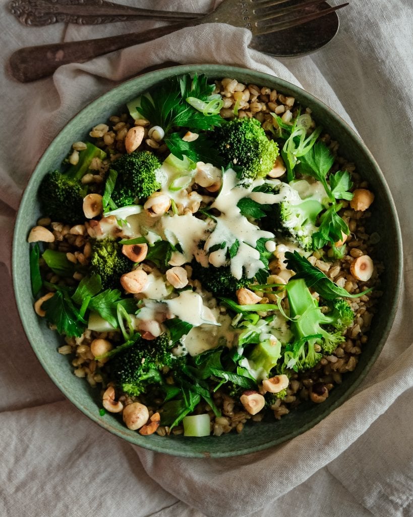 barley broccoli salad with tahini dressing from above close up
