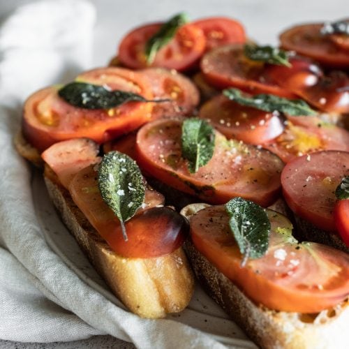 heirloom tomato bruschetta from side on plate