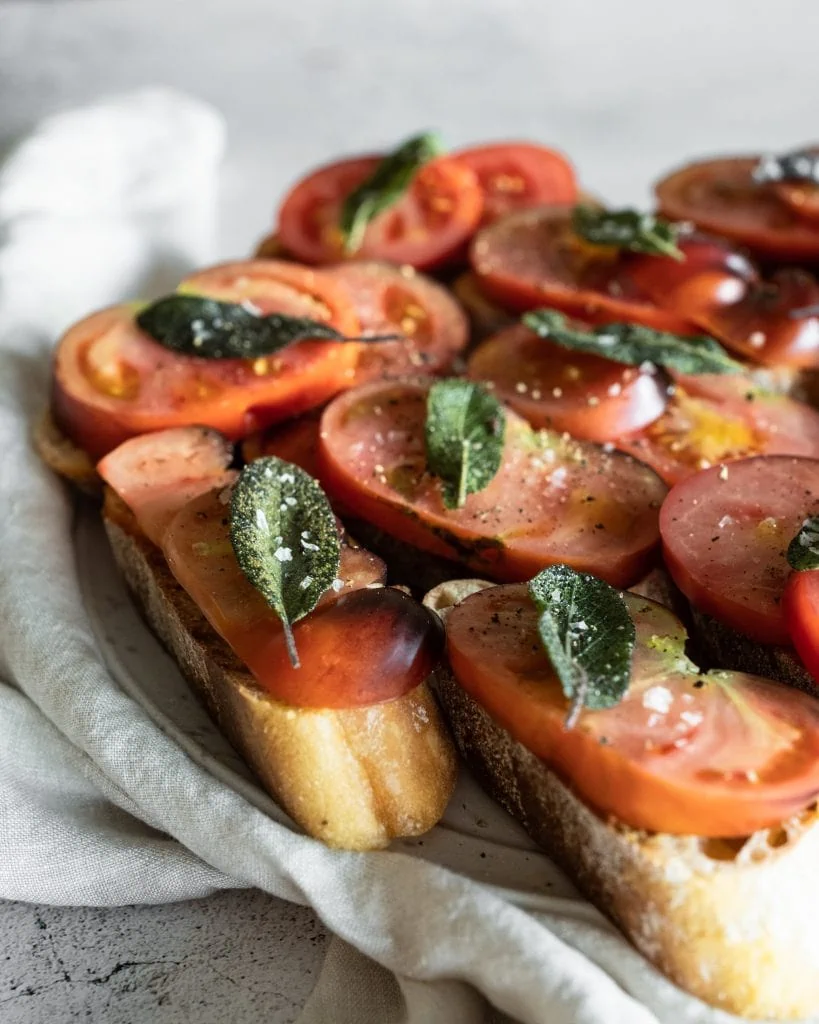 heirloom tomato bruschetta from side on plate