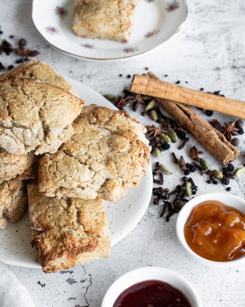 chai spiced scones with apricot and strawberry jam shot from the side